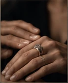 Hands wearing a fine ring